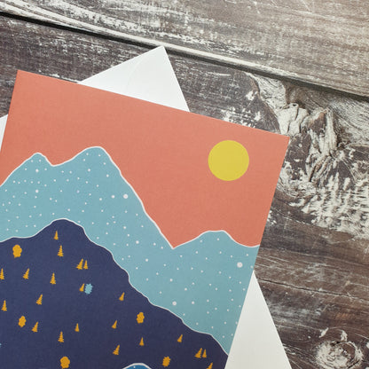 Blue Remembered Hills - Orange Sky Greeting Card